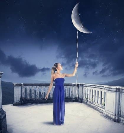 Girl holding a string attached to the moon