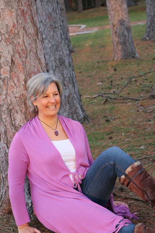 BlurryFave sue bowe sitting by a tree